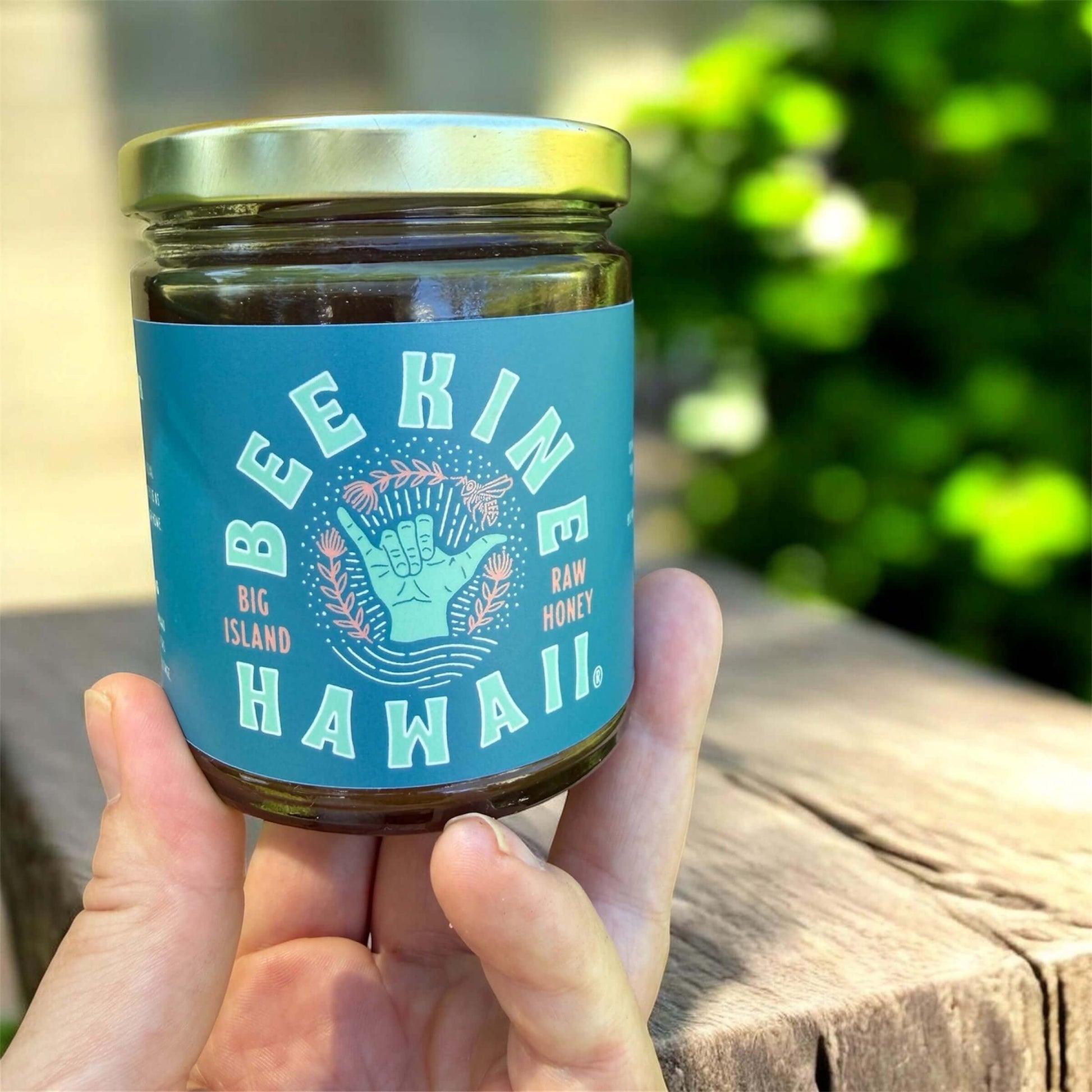 13.5 oz raw Hawaiian honey jar held in hand local Big Island honey