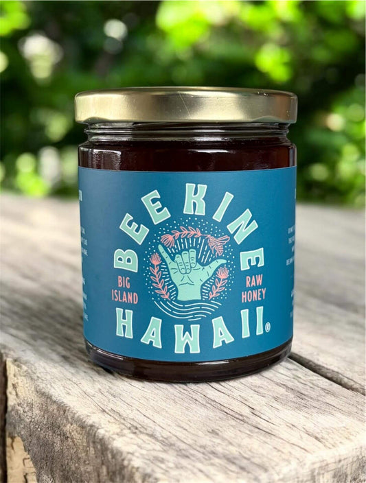 raw Hawaiian honey 13.5 oz jar on natural wood log Big Island Hawaii